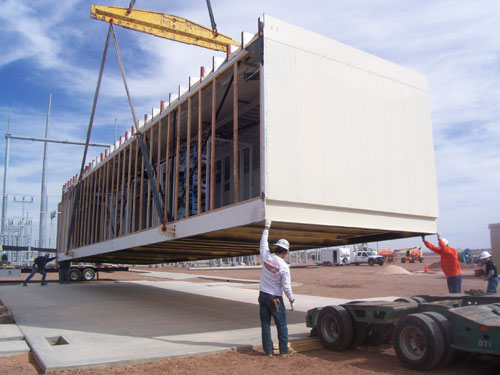 Delivery of a split enclosure section by crane.