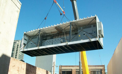 A section of a split enclosure being dropped into place