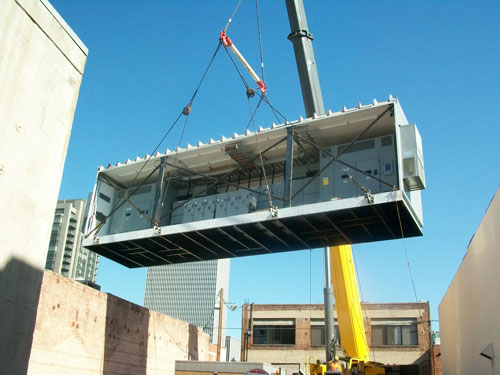 A section of a split enclosure being dropped into place